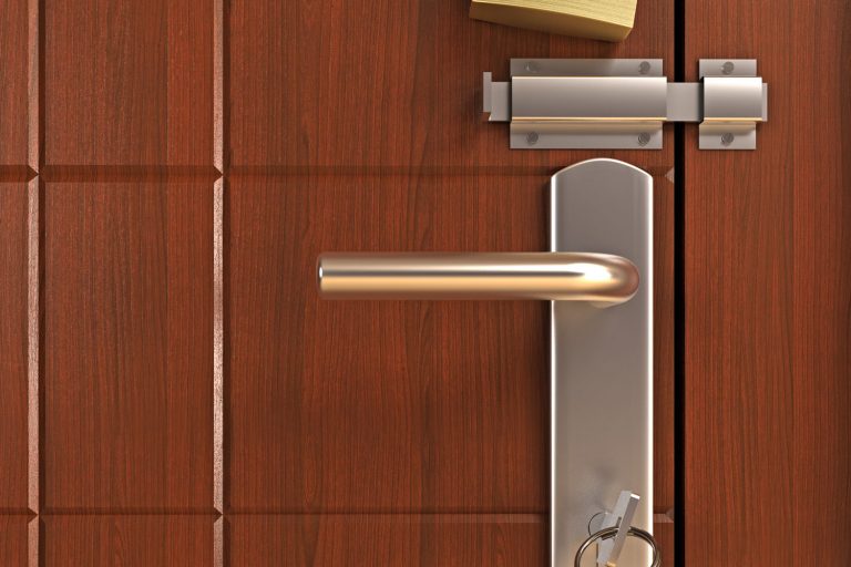A pure metal door latch on a hard wood door, What Are The Types Of Door Latches?
