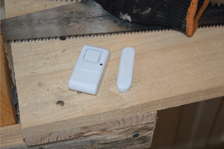 magnetic door alarm sensor on top of wood used for making door. Do Door Alarm Sensors Have Batteries