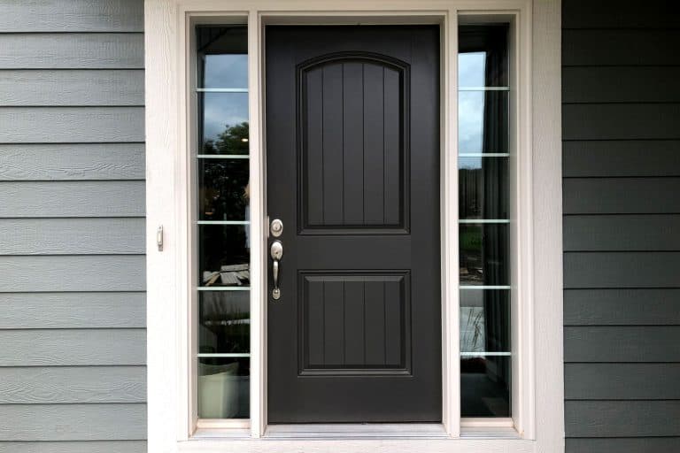 A brown front door with glass panels and an emerald painted wooden exterior siding, How To Fill Nail Holes On A Fiberglass Door