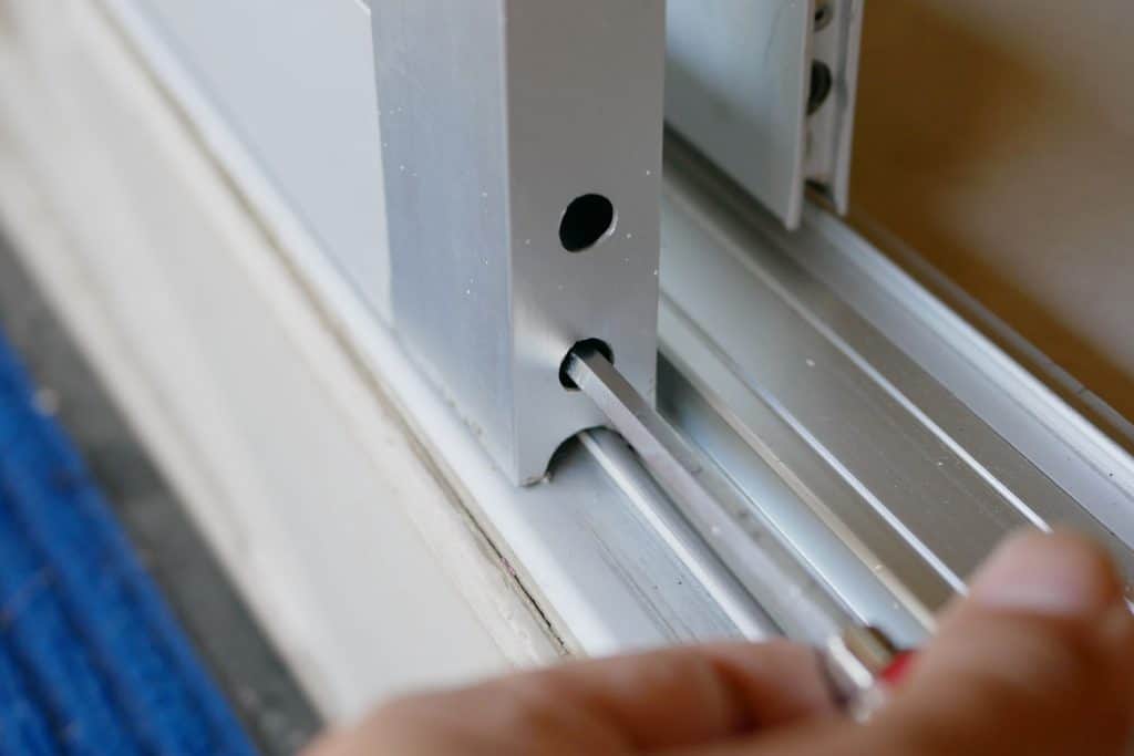 A man checking the mechanism of the sliding door