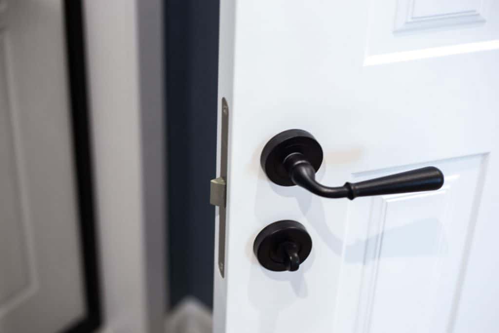 A black door handle in a front door