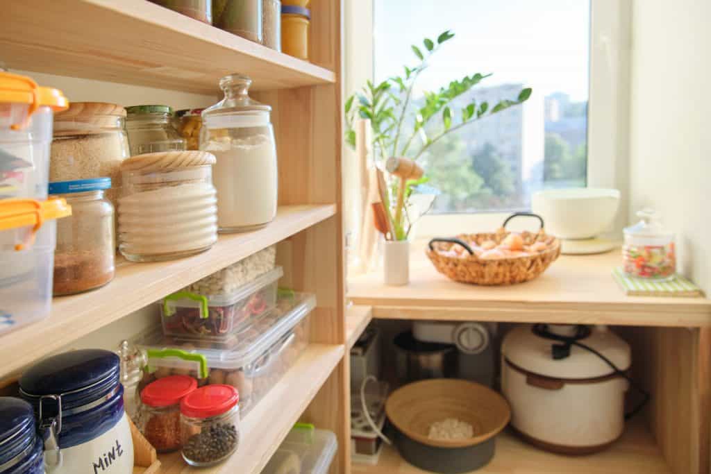 A small pantry with jars with spices and other cooking essentials