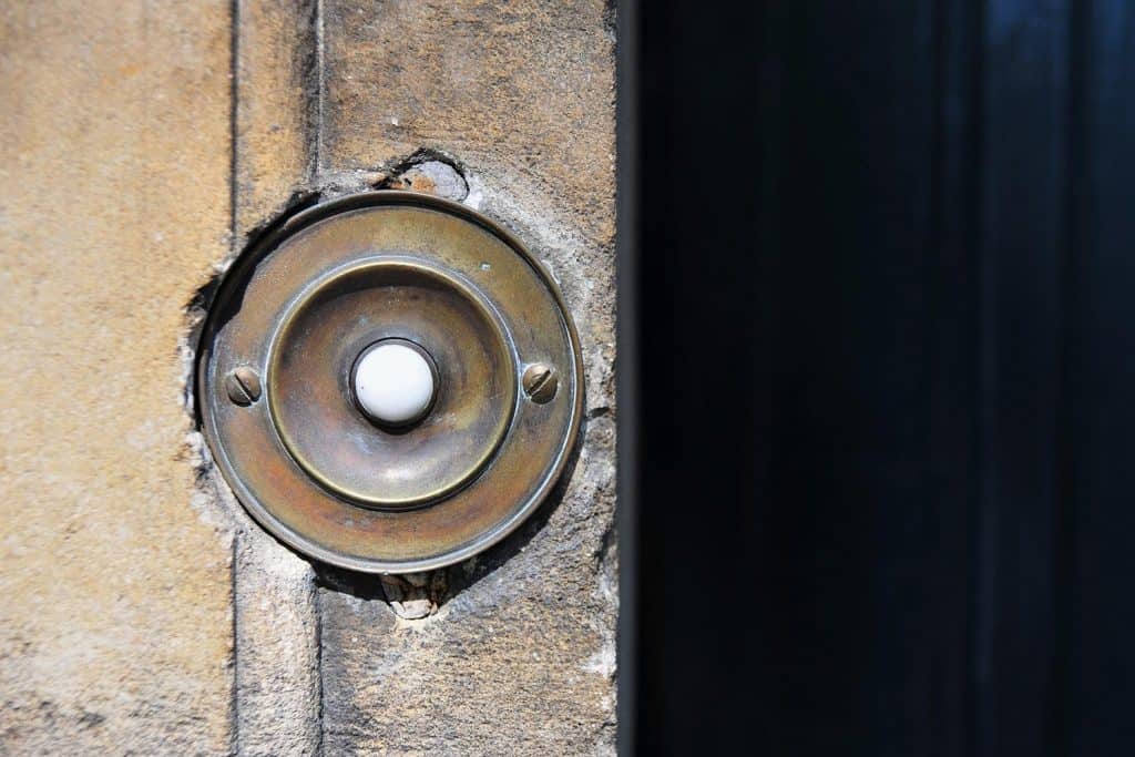 Closeup of vintage door bell in old stone wall