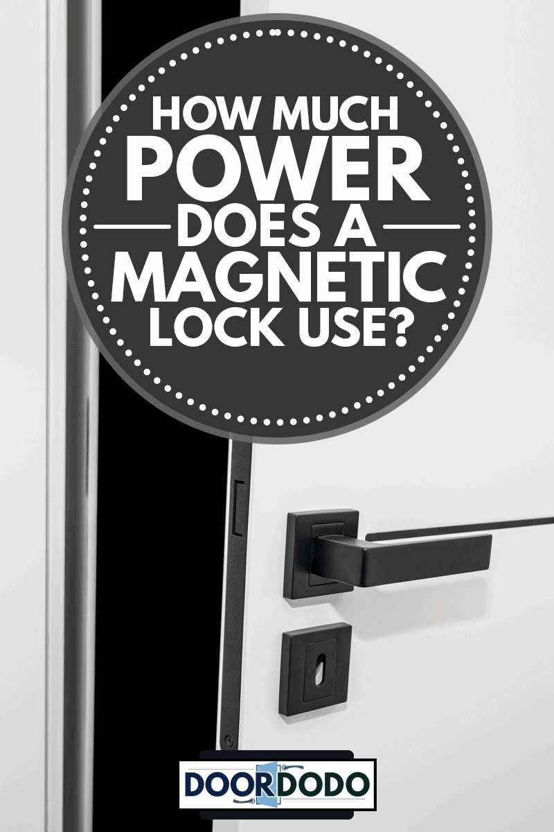 Modern white door with matte black handle and magnetic locks, lock with insert key., How Much Power Does A Magnetic Lock Use?