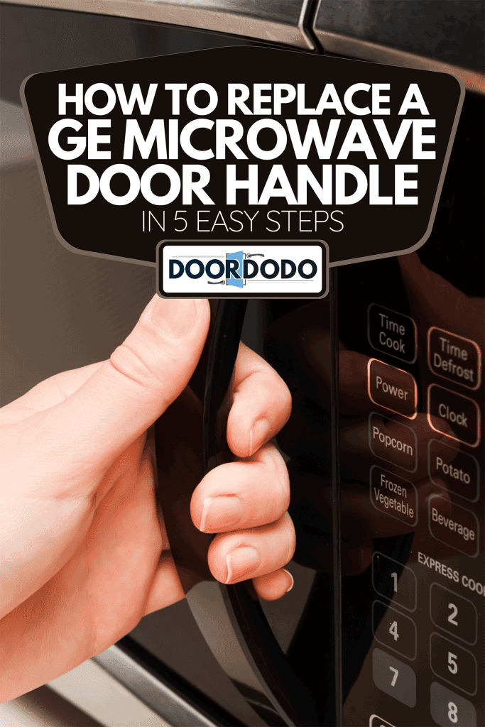 A hand holding microwave door, How To Replace A GE Microwave Door Handle In 5 Easy Steps