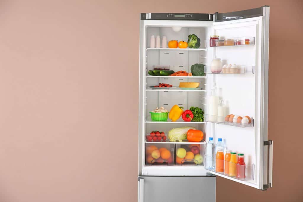 Open fridge full of food near color wall, How To Turn LG Refrigerator Door Alarm On And Off