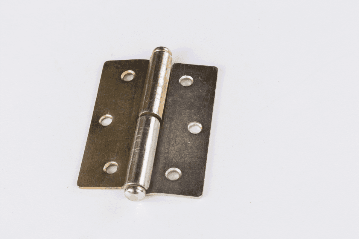 brass door hinge on a white table