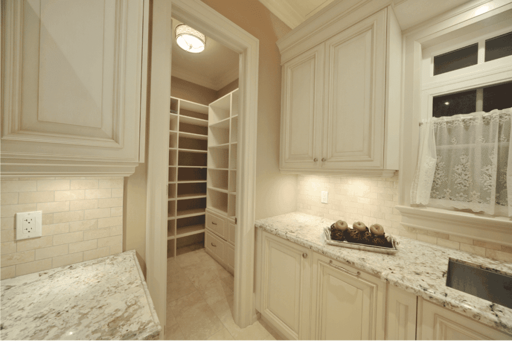 kitchen pantry with door and cabinets in matching cream color. Should Pantry Door Match Cabinets
