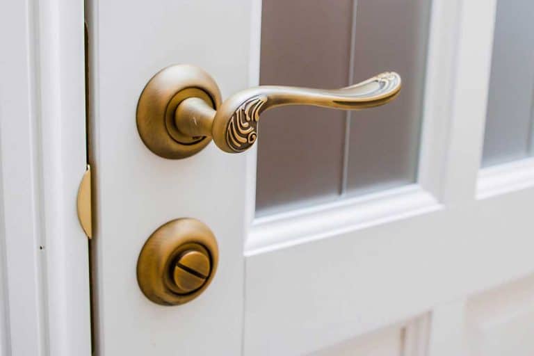 A brass doorknob with an ornament, Should Door Handles Match Throughout The House?