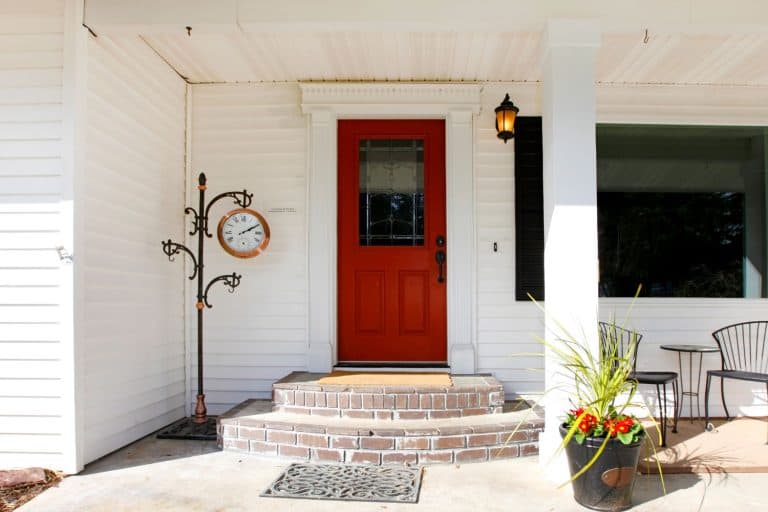 A red front door in the gorgeous white themed front porch, How To Install Or Remove Larson Storm Door Glass Panel