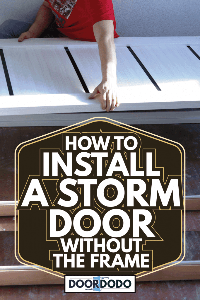 A storm door made of bleached larch in the hands of a contractor. How To Install A Storm Door Without The Frame