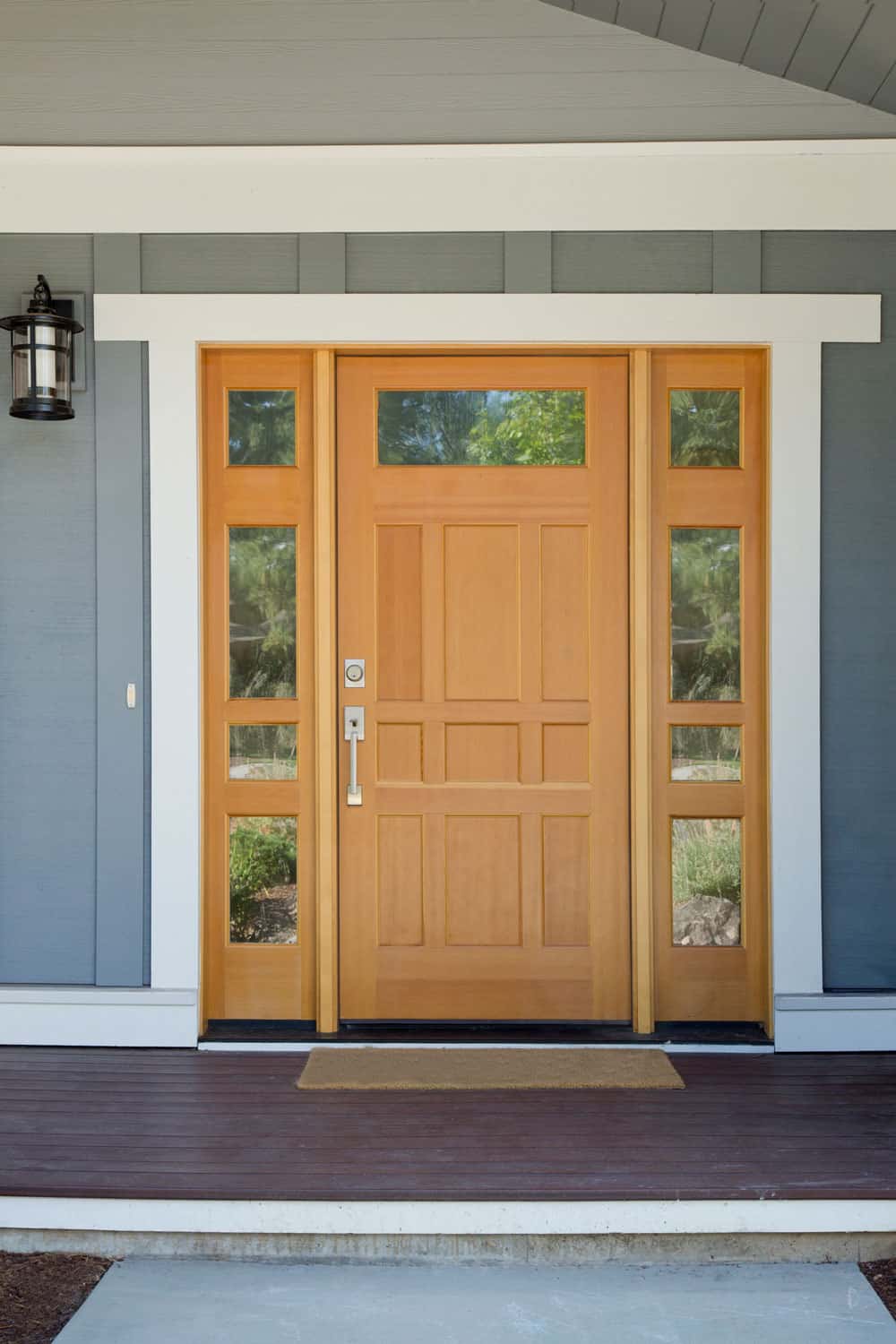 A wooden storm door with glass panels on the sides and white framing