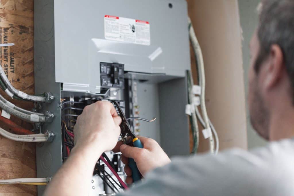 A worker installing an electrical panel