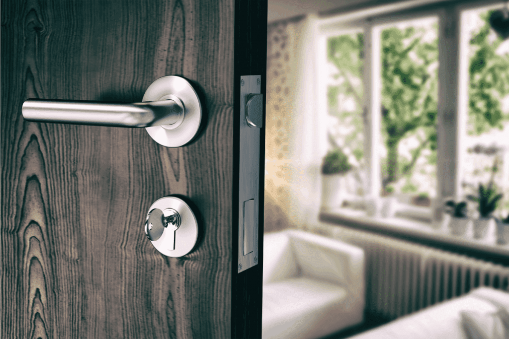 Brown door with handle and house key. How To Make A Door Handle Open Upwards
