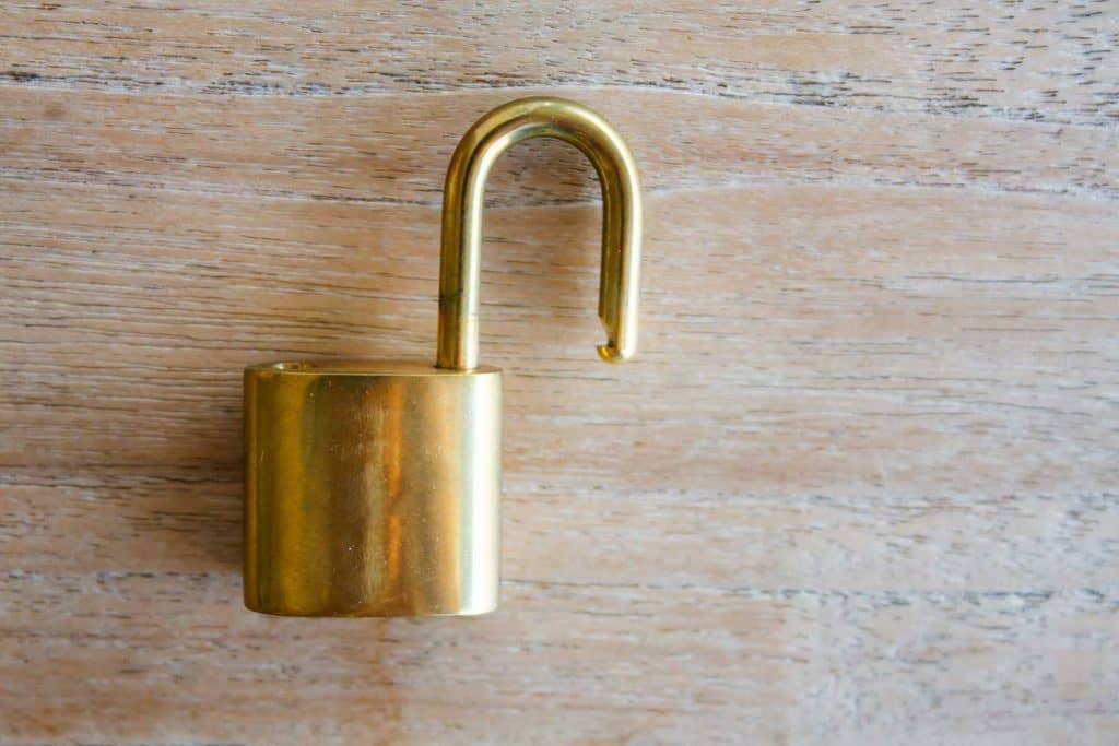 Golden padlock on wood background