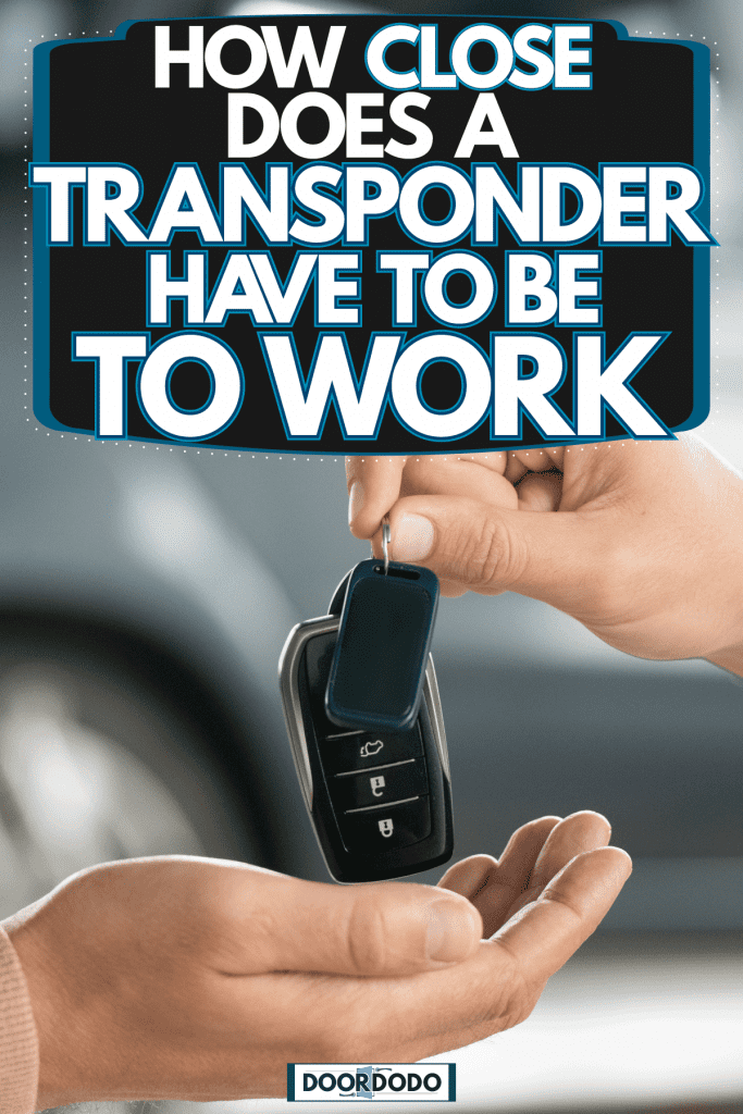 A woman holding her car keys, How Close Does A Transponder Key Have To Be To Work