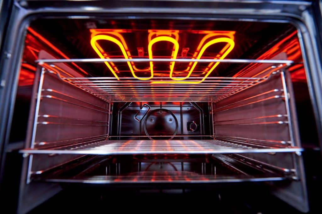 Interior of a large oven with rods glowing on brightly