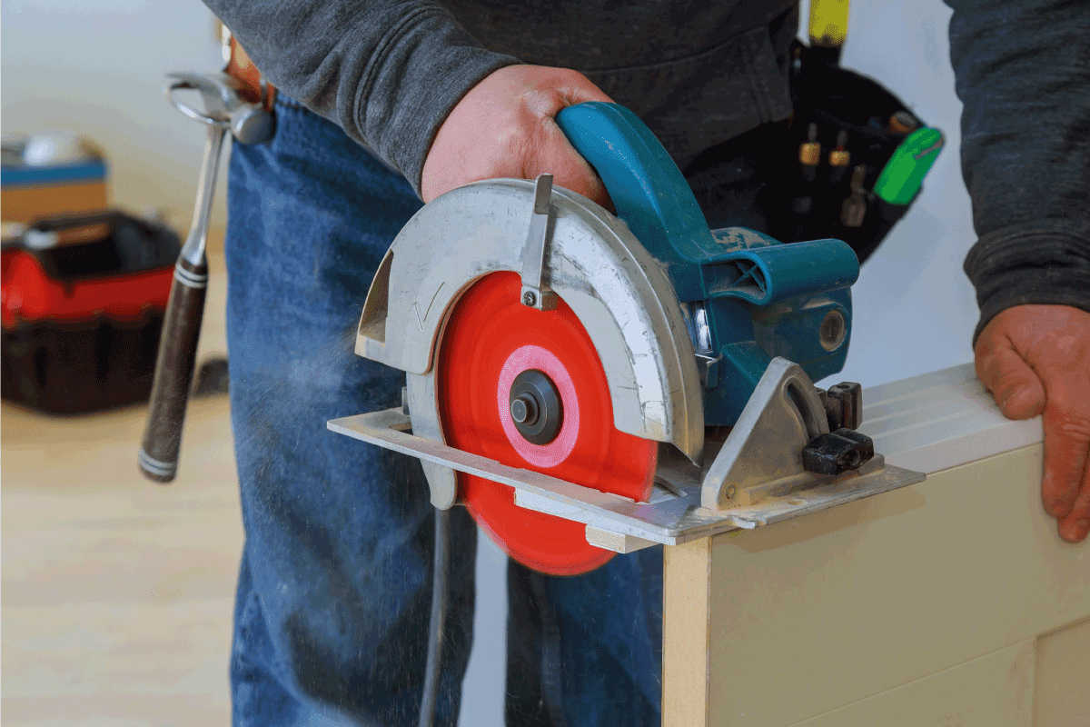 Man cutting wood door cuts circular saw the hands of the builder construction and home renovation. How Much Can You Cut Off A Solid Core Door