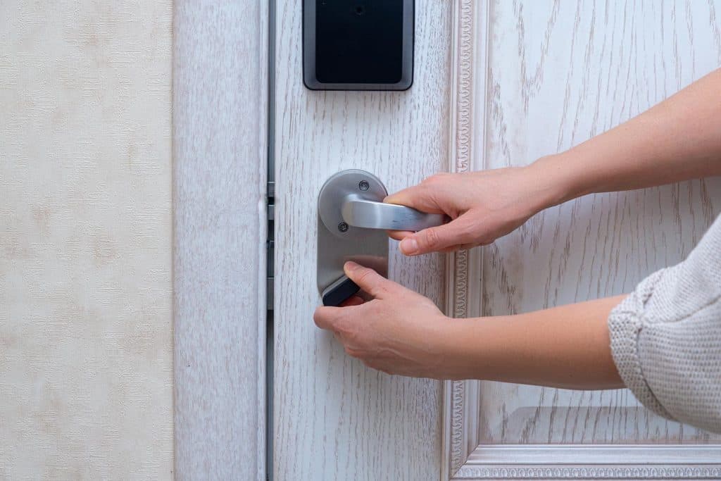 Woman closes door lock deadbolt