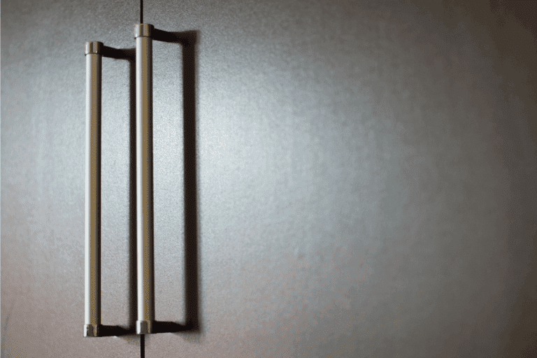 silver-handles-attached-to-a-smooth-brown-door.-How-Long-Is-A-Typical-Door-Handle