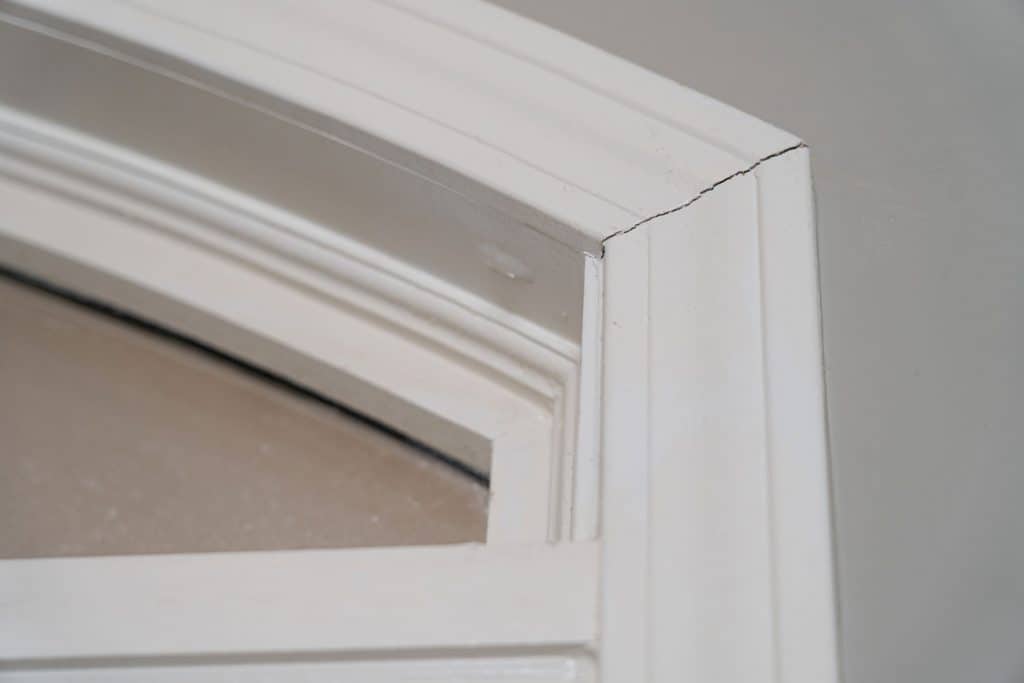 Gaps in trim molding around a door frame create unsightly cracks but are an easy DIY fix
