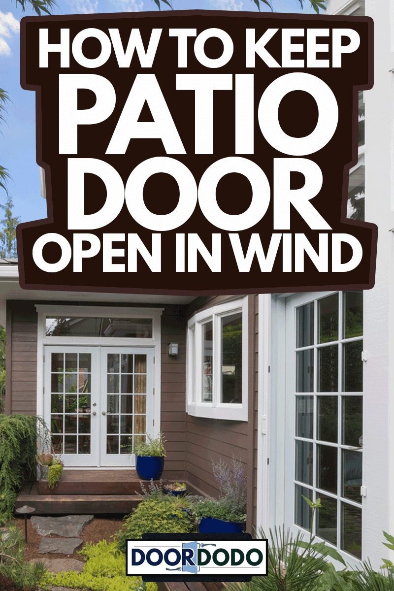 A narrow deck goes past patio doors in the backyard of this contemporary home, How To Keep Patio Door Open In Wind