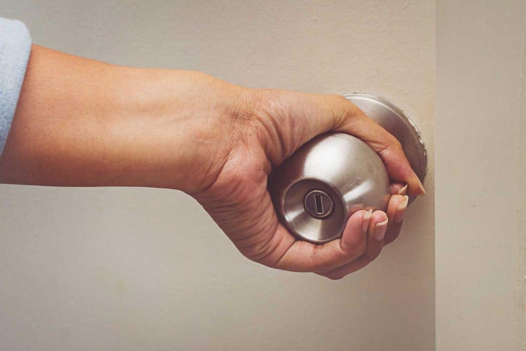 Women hand open door knob