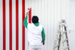 painter man working for repairing and painting the garage door, How To Stop Garage Door From Sticking After Painting