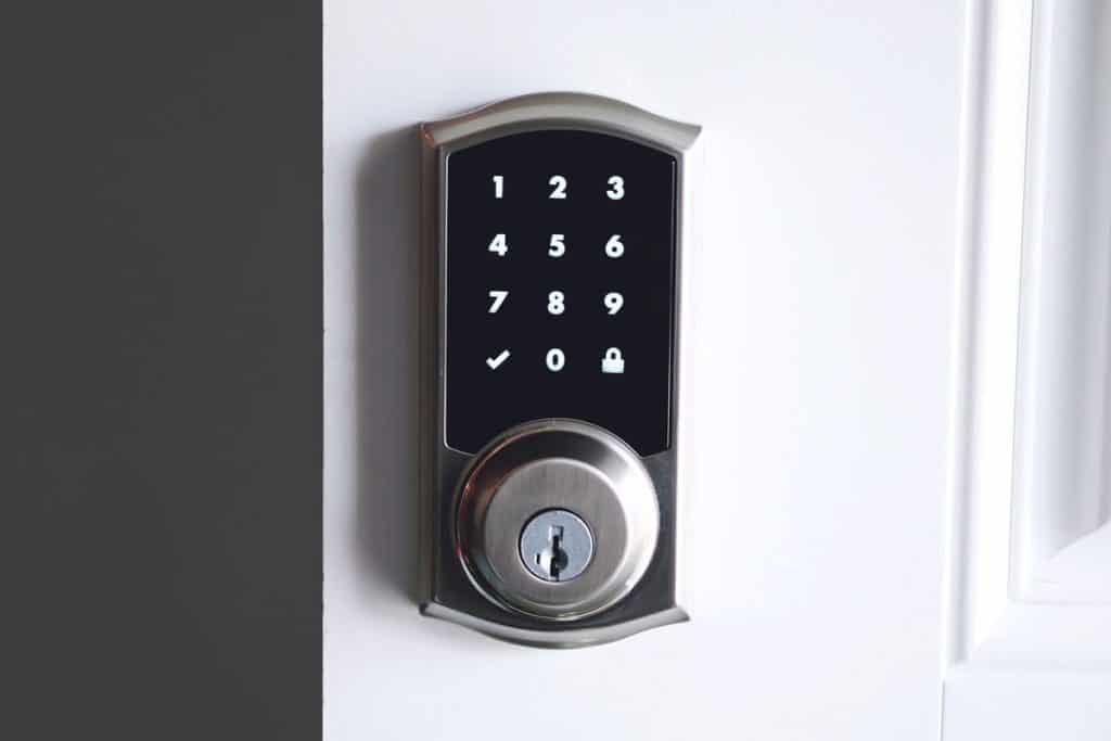 A touchscreen digital door lock with a key bypass
