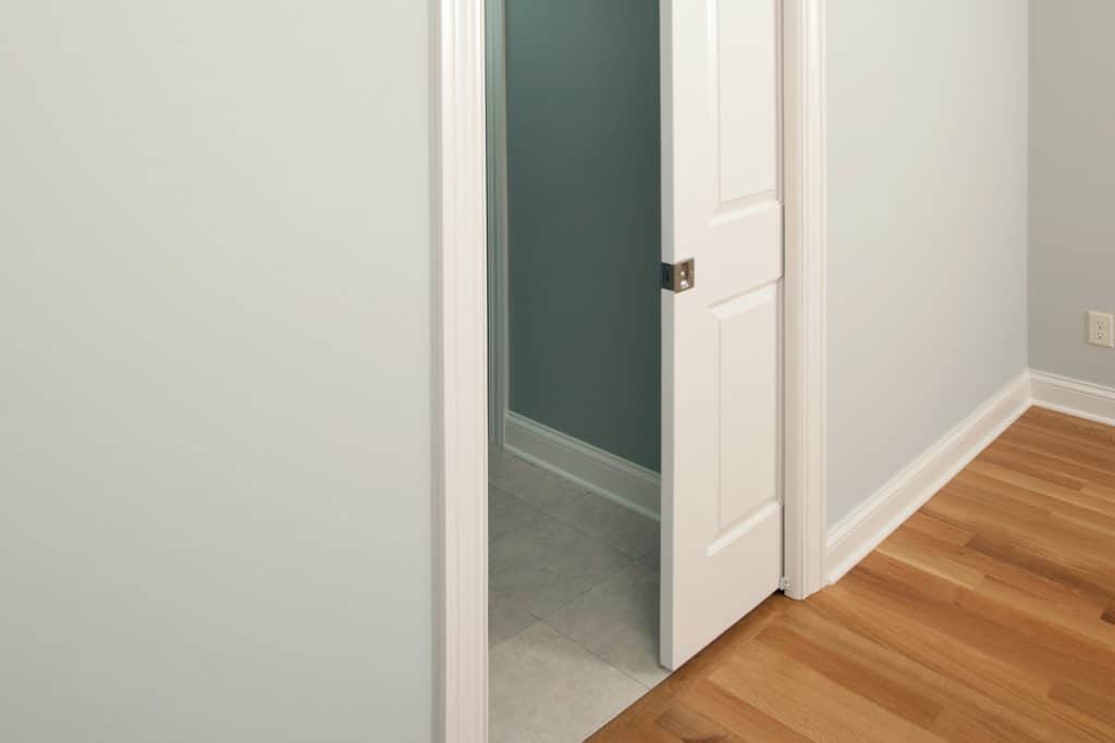 A white pocket door leading to a bedroom