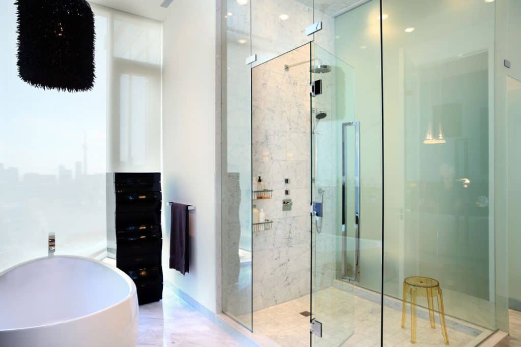 Interior of Interior of an ultra modern and spacious bathroom with a glass shower wall and door