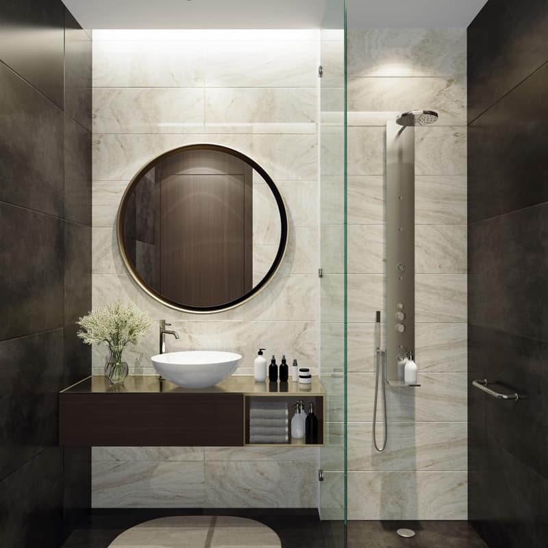 Contemporary designed bathroom with a glass shower wall and a round mirron on the vanity